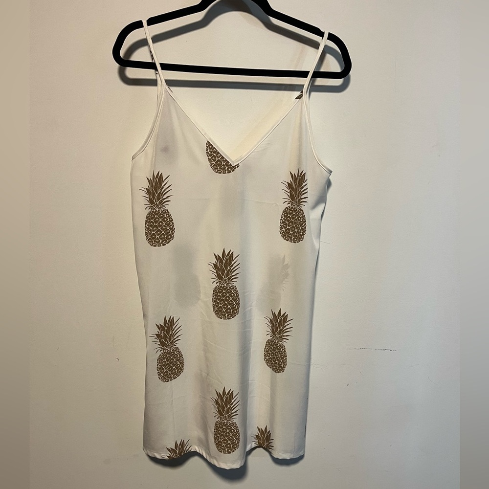White dress with gold pineapples.